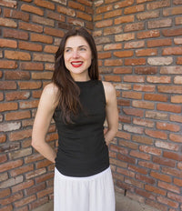 Taylor wears a small boatneck tank in black.